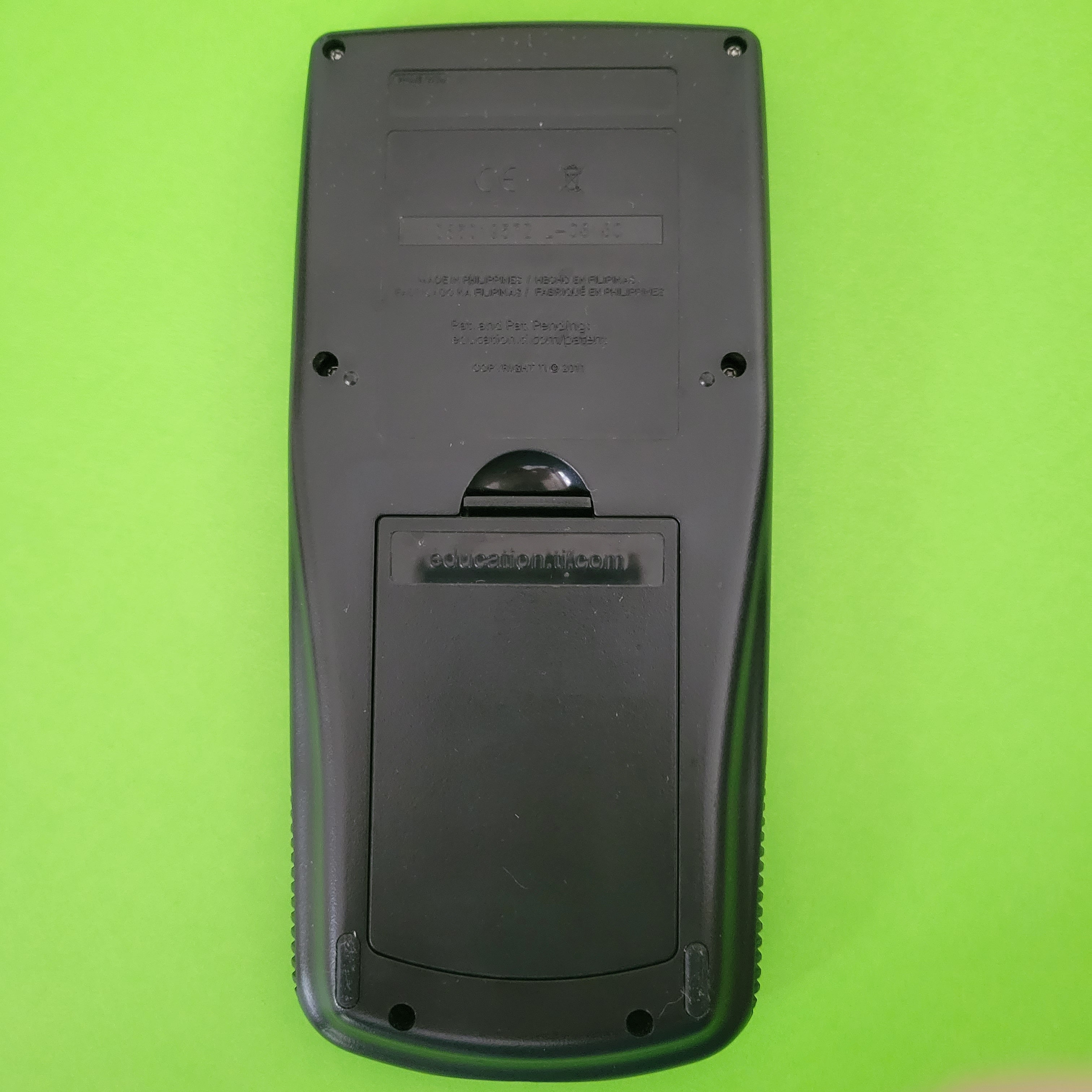 An image of the back of a texas instruments ti83 plus graphing calculator